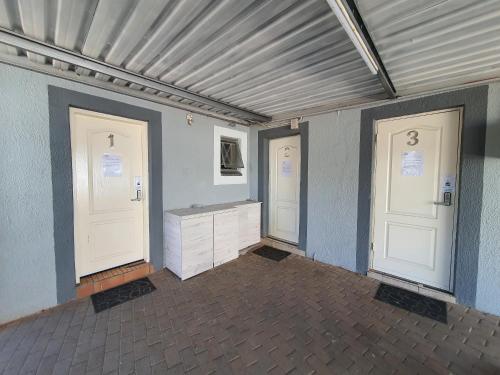 a room with three doors in a building at Inn-Finity Empire in Witfield