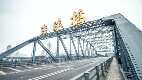 a bridge with signs on top of it at Argyle WAIFIDEN Baolidian Hotel -Free shuttle bus during Canton Fair in Guangzhou