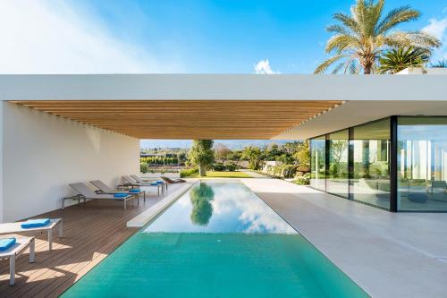 a swimming pool in the middle of a house at Hermosa in San Leonardello