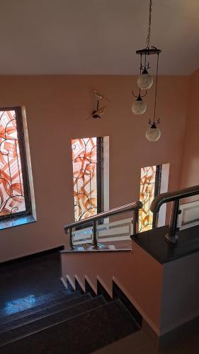 an empty room with stairs and stained glass windows at Villa Effy 3 Bedrooms - Entire Villa 1800 sq ft in Carmona