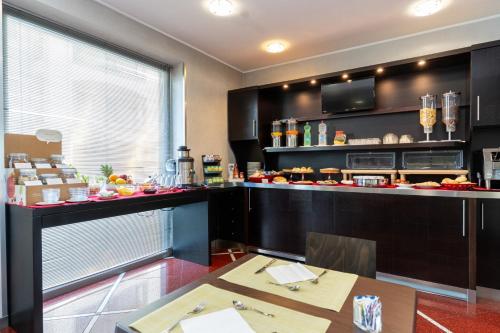 a kitchen with a counter and a table in a room at Hotel Majorana in Rende