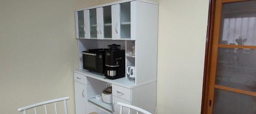 a white book shelf with a microwave and a microwave at 4BR BIG Private House ChoshiOcean in Choshi