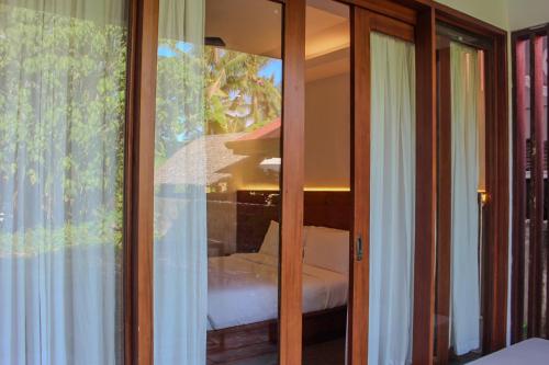 a reflection of a bedroom in a glass window at The Henry Resort Siargao at Kermit in General Luna