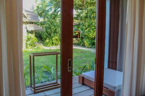 an open door with a view of a yard at The Henry Resort Siargao at Kermit in General Luna
