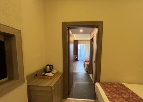 a hotel room with a bed and a hallway at Master Family Club in Manavgat