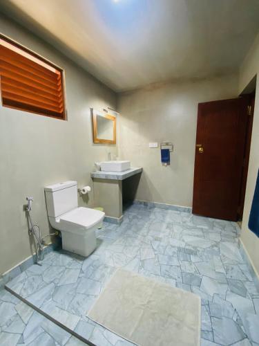 a bathroom with a toilet and a sink at Dana Villa in Bentota
