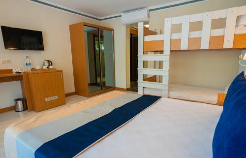 a bedroom with a bunk bed and a tv at Master Family Club in Manavgat