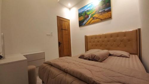 Postel nebo postele na pokoji v ubytování Tirta Village Homestay