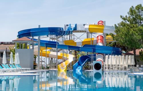 a water slide in a pool at a resort at Master Family Club in Manavgat