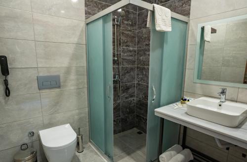 a bathroom with a shower and a toilet and a sink at Master Family Club in Manavgat