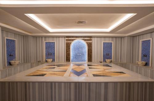 a rendering of a large room with a blue fountain at Master Family Club in Manavgat