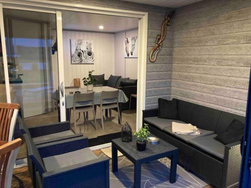ein Wohnzimmer mit Sofa und Tisch in der Unterkunft Mobil Home piscine chauffée Pont l 'Abbe in Pont-lʼAbbé
