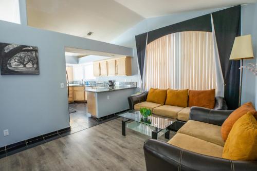 a living room with a couch and a table at Luxury 1900 SQ FT House Huge 46 FT Pool & Hot SPA in Las Vegas