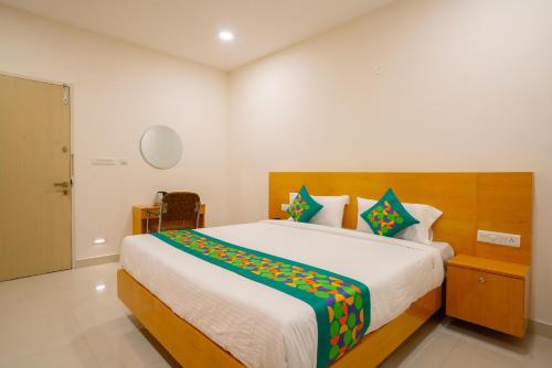 a bedroom with a large bed in a room at Treebo The Living Tree Khairatabad in Hyderabad