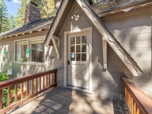 a house with a wooden porch with a door at Troubadour's Landing in Kings Beach