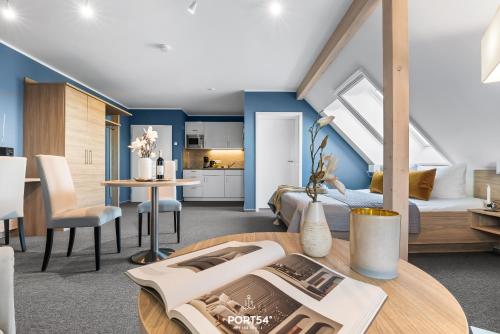 a loft bedroom with a bed and a dining room at Ferienwohnung Bude 2 Dagebüll in Dagebüll