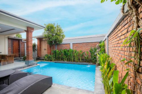 a swimming pool in the backyard of a house at Ubud Mayura Private Pool Villa in Ubud