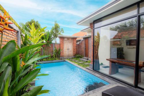 a swimming pool in the backyard of a house at Ubud Mayura Private Pool Villa in Ubud