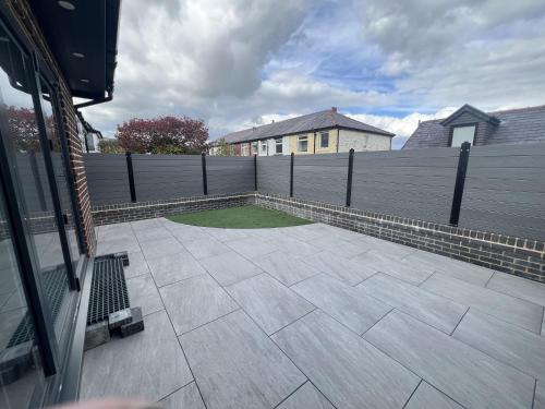 a backyard with a fence and a grass yard at Whole house -Sleeps4-Parking-Garden-BikingHiking in Bury