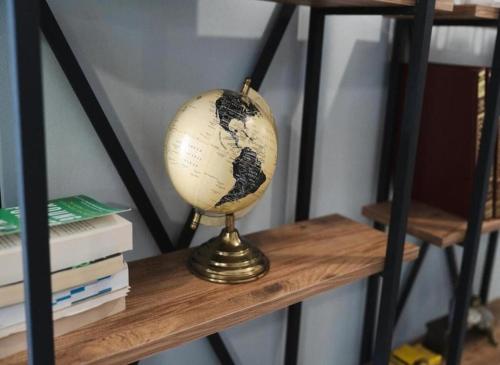 a globe sitting on top of a wooden shelf at Rea Apartment in Argostoli