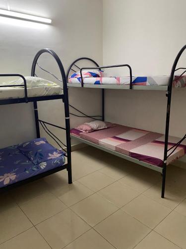 a room with two bunk beds in a room at HomeStay Family Fun Shah Alam in Shah Alam