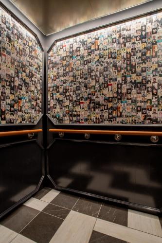 a room with a wall covered in lots of tiles at The Bell Athens by Kasa in Athens
