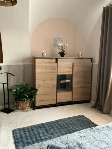 a wooden dresser in a room with at Apartmány na Náměstí in Český Brod