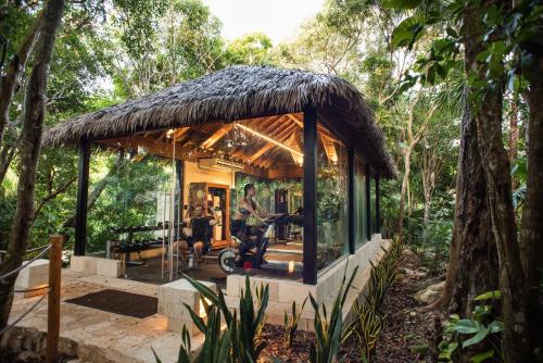 a small house with a thatched roof in the forest at Viceroy Riviera Maya, a Luxury Villa Resort - Adults Only in Playa del Carmen