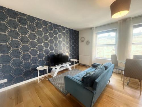a living room with a couch and a tv at Alma Vale Apartments 4 - Hopewell in Bristol