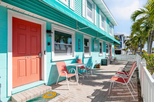 a colorful house with chairs and a table outside at Bayview Inn #101 in Bradenton Beach