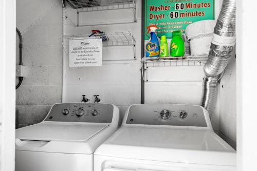 a bathroom with a washing machine and a sink at Bayview Inn #101 in Bradenton Beach