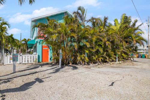 a row of palm trees in front of a building at Bayview Inn #101 in Bradenton Beach