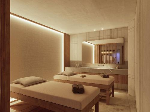 a room with two beds and a mirror at Anantara Convento di Amalfi Grand Hotel in Amalfi