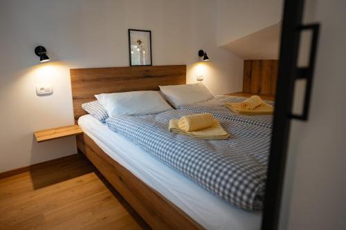 a bedroom with a bed with two towels on it at Pr Štepiherju in Luče