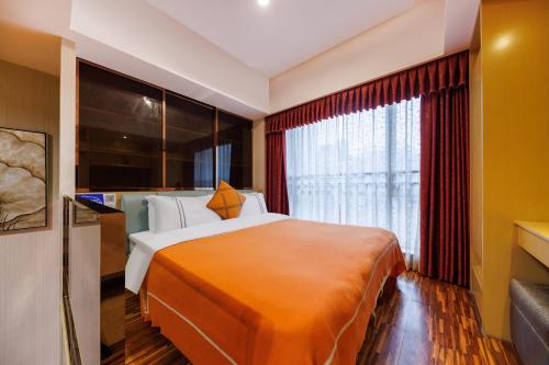 a hotel room with a large bed and a window at Guangzhou Xi Yun - Lai Xizhou Hotel-Free shuttle bus during Canton Fair in Guangzhou