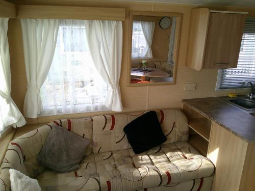 a living room with a couch in a kitchen at Highfields Rio 6 berth blow heated in Skegness
