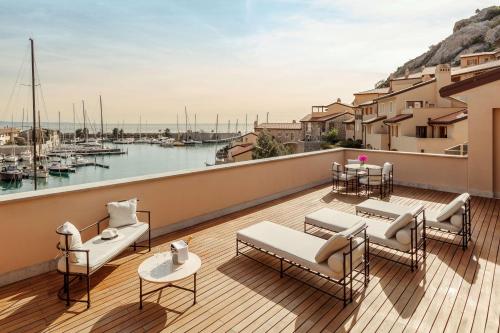 a balcony with furniture and a view of a harbor at Tivoli Portopiccolo Sistiana Wellness Resort & Spa in Sistiana