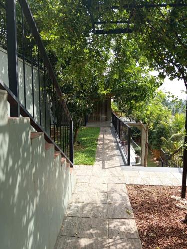 a walkway leading up to a house with a fence at Villa Rumassala Luxury Chalets Unawatuna in Unawatuna