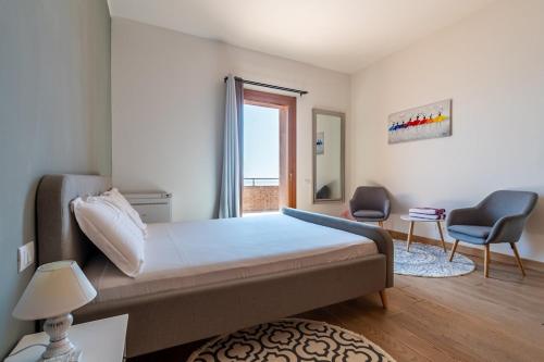 Ένα ή περισσότερα κρεβάτια σε δωμάτιο στο Villa Praesidium pied dans l'eau, on the beach