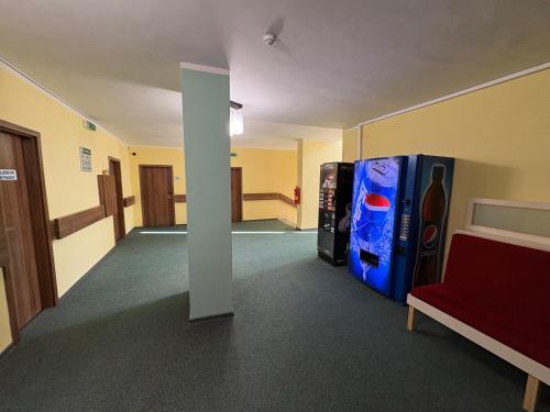 an empty room with two refrigerators and a couch at Hotel Opera in Jaroměřice na Rokytné