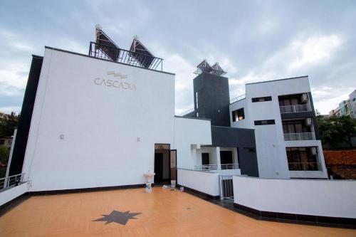 a white building with a star on the front at Cascadia Apartments Kigali in Kigali