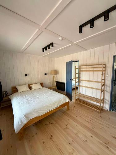 a bedroom with a bed and a ladder in it at Oberża pod Złotym Prosiakiem in Nieborów