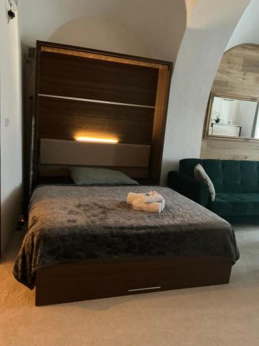 a bedroom with a large bed with a large headboard at Apartmány na Náměstí in Český Brod