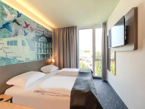 Postel nebo postele na pokoji v ubytování B&B HOTEL Offenburg-Hbf