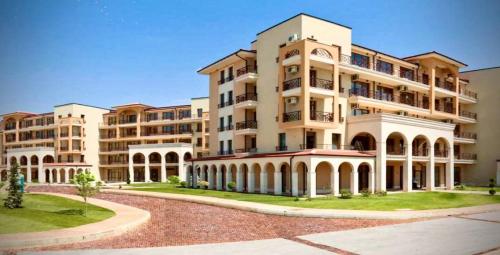 a large apartment building with a pathway in front of it at Sunny Ap in Golf Complex Lighthouse in Balchik
