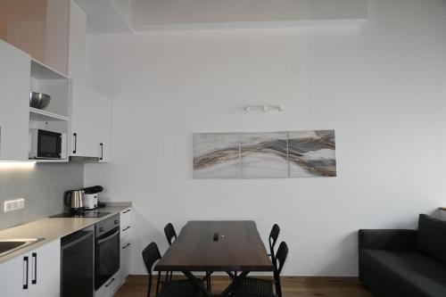 a kitchen with a table and chairs in a room at Homenfun Dalt Badalona in Badalona