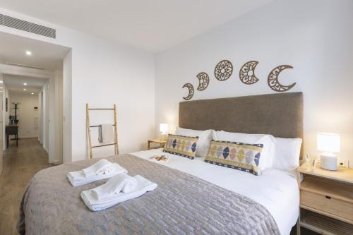 a bedroom with a large bed with towels on it at Nova Essential in Jávea