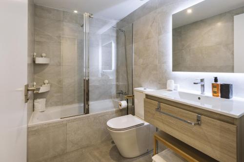 a bathroom with a toilet and a sink and a shower at Nova Essential in Jávea