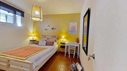 a bedroom with a bed and a table in it at For Sea Lovers in Cubelles