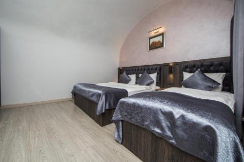 a hotel room with two beds in a room at Passage Hotel in Baku